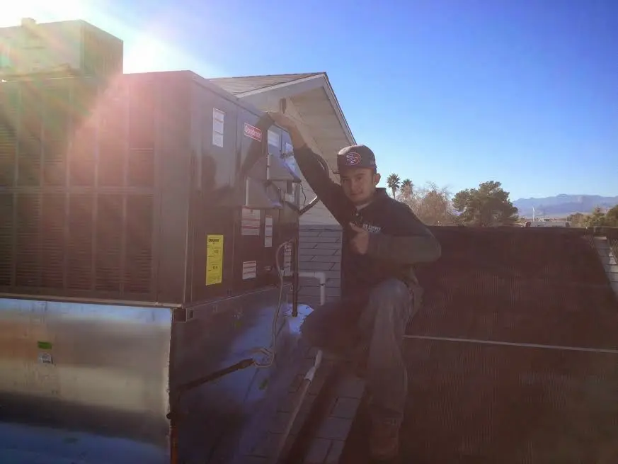 HVAC technician performing Heat Pump Repair on a rooftop unit in Lutz